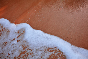 Wave On Sandy Beach. Background. Splash of waves on the sandy beach. foam, surf, waves.