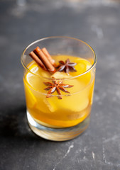 Healthy hot beverage with lemon, ginger and spices for protection in flu season. Selective focus. Shallow depth of field.