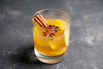 Healthy hot beverage with lemon, ginger and spices for protection in flu season. Selective focus. Shallow depth of field.