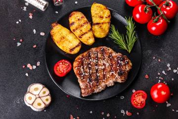Ribeye steak with potatoes, onions and cherry tomatoes