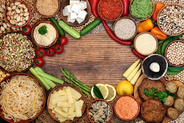Health food for a vegan diet background border with falafel & burgers, fruit, vegetables, grains, tofu, pasta, nuts, dips & legumes. High in immune boosting vitamins, minerals, antioxidants & fibre.