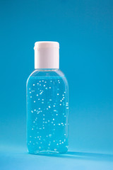 A bottle of hand sanitizer gel. Hand hygiene as coronavirus protection. Antivirus and antibacterial product. Blue liquid with white round granules