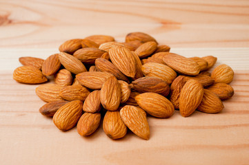Almonds nuts shot large on a wooden background. Background for healthy eating and vegetarianism.