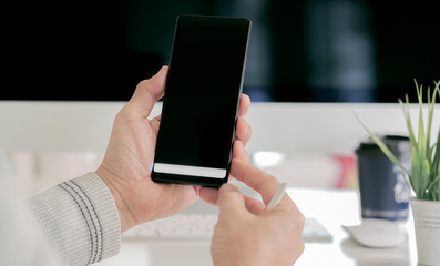 Closeup man hand holdng smartphone with black screen.