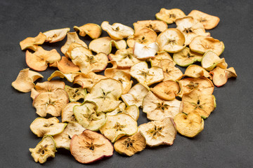 Slices of dried apples on black background. Healthy Diet Snack. .