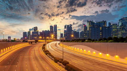 Fototapeta na wymiar Singapore city highway traffic with movement of car light with Singapore cityscape skyline and skyscraper background.