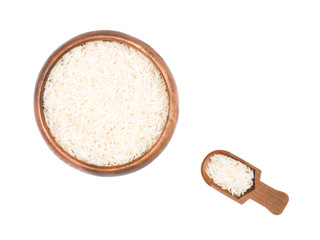 Indian long grain Basmati rice in brown wooden bowl and scoop isolated on white. Indian cuisine, ayurveda, naturopathy concept