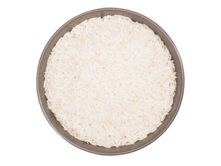 Indian long grain Basmati rice in brown ceramic bowl isolated on white. Indian cuisine, ayurveda, naturopathy concept