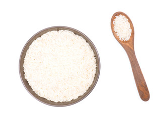 Indian long grain Basmati rice in brown ceramic bowl and wooden spoon isolated on white. Indian cuisine, ayurveda, naturopathy concept