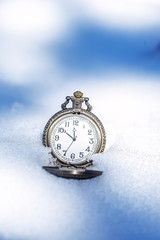 Historic watch on winter background.
