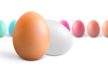 Brown and white eggs against multicolored, isolated on white background