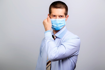 Recovered man wearing medical mask, removes mask