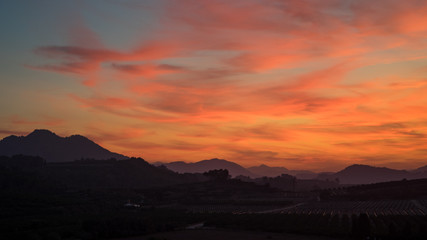 Amazing warm sunset light in the clouds over spanish hills of Valenciana region