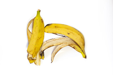 Food waste bananas on a white background. Top view. Flat lay. Waste for recycling. Responsible disposal of household food wastage in an environnmentally friendly way by recycling.