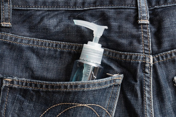 Anti-coronavirus spray. A man Carry it in the pant pocket