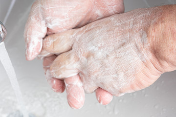 Fototapeta premium A man washing his hands