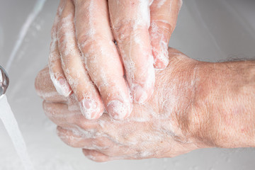 Fototapeta premium A man washing his hands