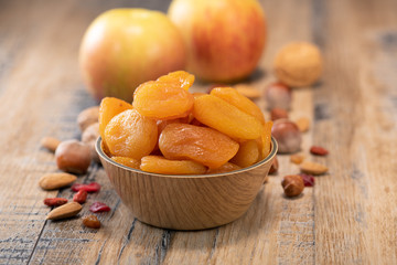 Apricots, Dried fruit and apple composition on wood background