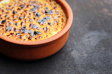 Creme brulee, a sweet French dessert with caramelized sugar crust. Appetizing, sweet dessert with cream, eggs and caramelized sugar crust.