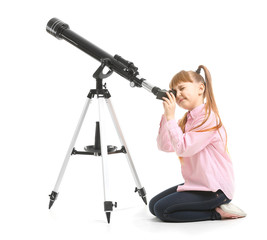 Cute little girl with telescope on white background