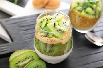 Glass with tasty panna cotta on table