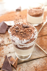 Glass with tasty panna cotta on table