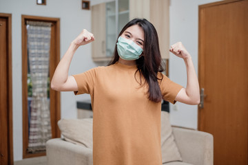Portrait of a cheerful and healthy young woman asian wearing medical mask. Pandemic 2019 Coronavirus COVID-19 Concept.