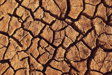 Dry cracked earth background in arid season. Many Province of North East in Thailand the ground dry. Brown cracked soil in the summer When water in Mekong, canal, brook, reservoir, dry up. Dryness.