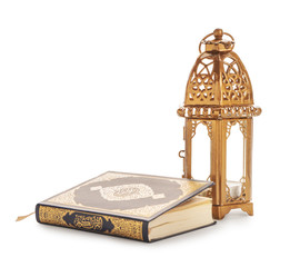Muslim lamp and Koran on white background