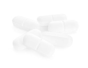 Heap of pills on white background