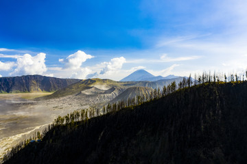 View from above, stunning aerial view of the Mount Bromo crater in the background and a silhouette...