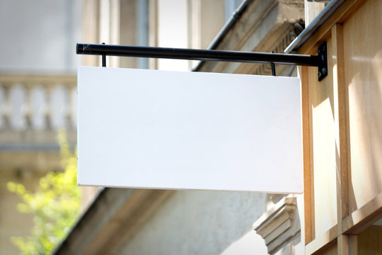 Blank sign board on a shop wall