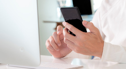 Closeup view of man hand using smartphone at home.