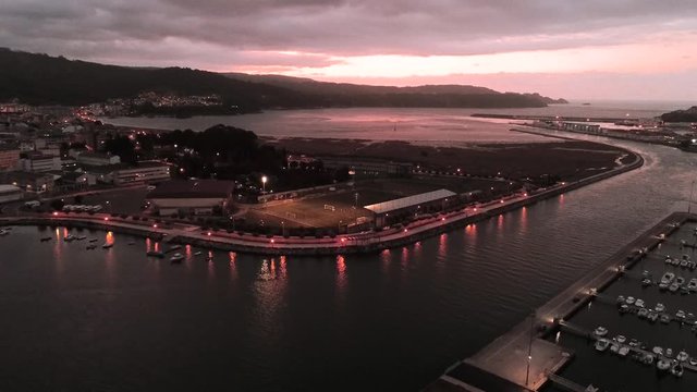 Tilt Down Aerial View Of Beautiful Marina At The Town Of Viveiro In The Evening, With Yacht Parking, In Lugo Province Northwestern Galicia.