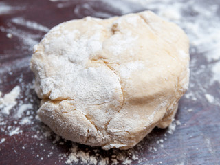 Fototapeta na wymiar piece of dough on the table and flour.