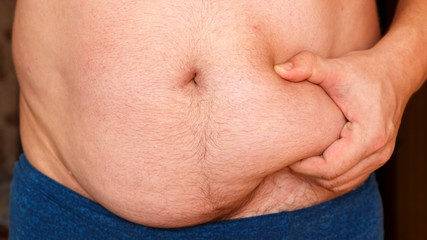 Man showing his fat on the stomach