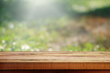 Wooden table and blurred nature garden background. Spring nature season.