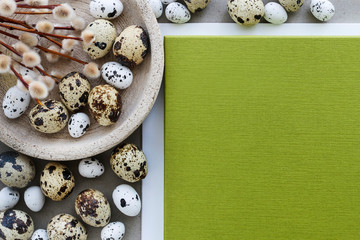 Quail eggs and sheet of paper, Easter background