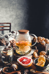 Hot tea with slices of fresh grapefruit on wooden tablet. Healthy drink, Eco, vegan