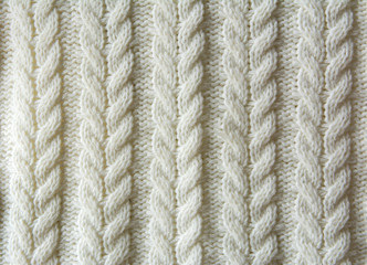 White Knitted wool texture of a fabric with cable knit pattern
