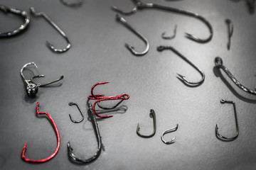 various fishing hooks on the table and offset and jig heads and tees for spinning and carp