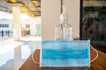 Corona virus or COVID-19 prevention concept, Medical surgical mask and hand sanitizer bottle on table for hand hygiene to help stop spreading outbreak coronavirus covid-19 for public health safety