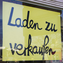 Laden zu verkaufen translates as store for sale in german - sign in shop window - economy crisis or...