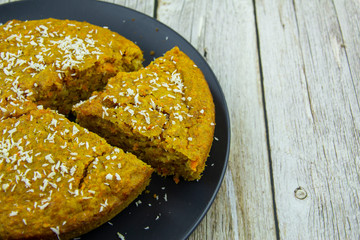 Carrot cake with coconut shavings on a plate