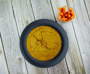 Carrot cake with coconut shavings on a plate