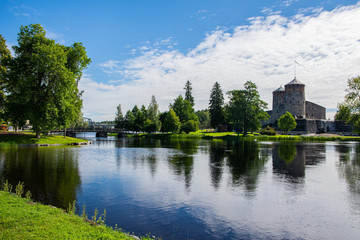 Fototapeta na wymiar View to Olavinlinna Castle and lake from the shore in summer, Savonlinna, Finland
