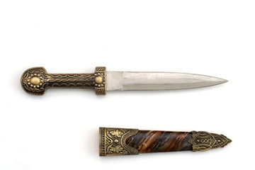 Ornate ceremonial dagger next to a jeweled scabbard