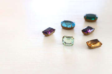 Beautiful crystal clear jems over white wooden background