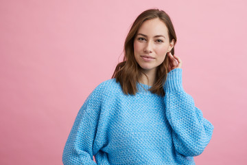 Portrait for beautiful woman on a pink background, colorful portrait