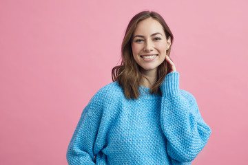 Portrait for beautiful smiling woman on a pink background, colorful portrait